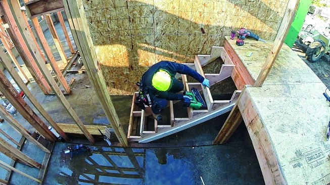 Then he nails on the remaining risers.