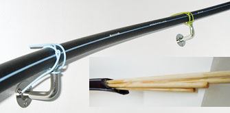 With the railing body temporarily wired to its mounts, Vartiala stiffened the assembly by inserting a bundle of seven pine dowels (inset) and filling the remaining space with flowable West System marine epoxy (westsystem.com). A small air-bleed hole was left at the plugged bottom of the rail, and a slow-curing hardener was used to allow the resin to flow and settle into the pipe before stiffening up. By comparing the interior volume of the pipe and the space occupied by the battens with the amount of resin used, Vartiala confirmed that few voids remained unfilled.