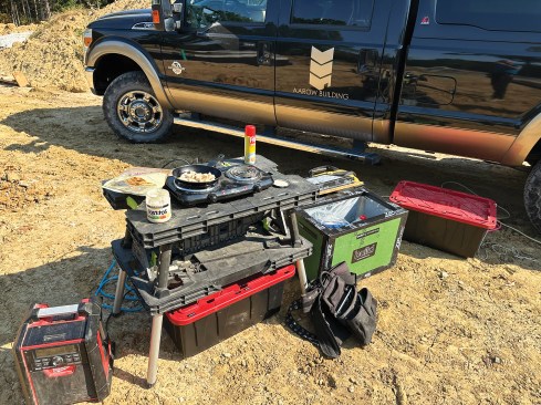 A hot plate keeps lunch warm on the jobsite. The project manager built the cooler to the right of it from scraps of Zip System R-Sheathing.