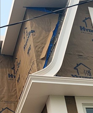 After cooling, the trim retains its curved form (left). For this project, crown molding was used to provide the flared edge common on many homes designed in Dutch Colonial and Tudor Revival styles (above).