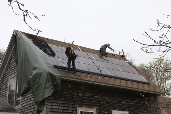The crew that came to do the work used all the proper fall protection gear, a wise choice working on a 10:12 pitch roof more than two stories above the ground.