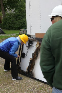 An investigator from the team examines the first solar panel (from the back), after it was taken down from the array.