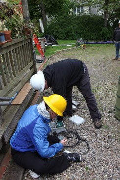 Then the investigator hunkers down on the driveway to get a close look at all the parts involved in the fire.