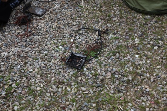 A charred part identified as an optimizer awaits scrutiny from the investigation team.