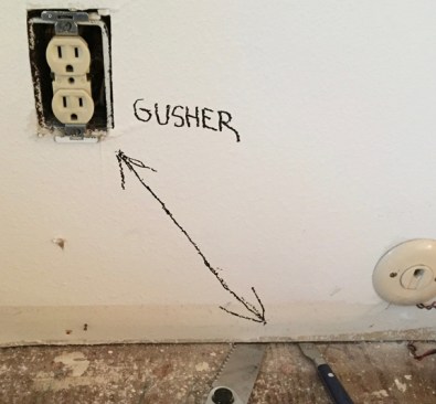 During an early blower-door test, the air flowing through this outlet and from the crack at the base of the wall gushed air.