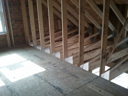 To construct a typical bonus room, the builder first installs OSB subflooring on the truss chord.