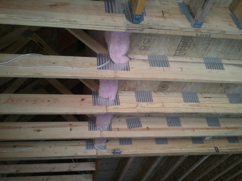 The vertical sidewall truss webs are insulated with kraft-faced fiberglass batts.
