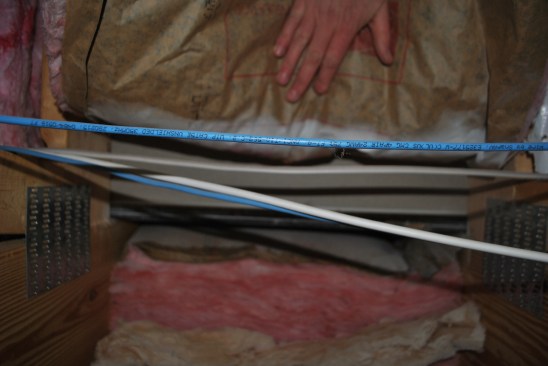 Where the wall meets the floor, nothing blocks air from flowing through fiberglass batts installed under the subfloor