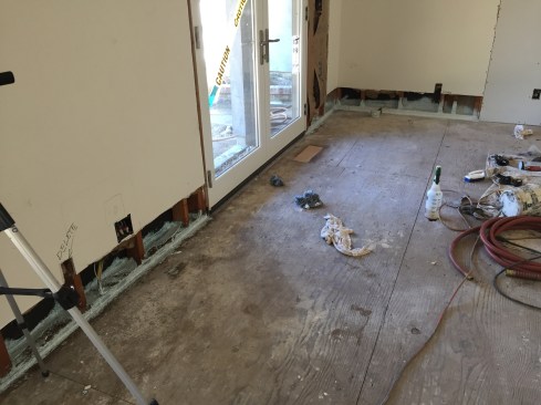 Working from the inside, we RotoZipped a 12-inch strip of drywall off the entire bottom of the drywall along the exterior walls and a few interior walls loaded with bottom plate punctures.