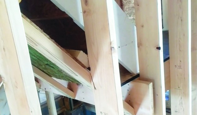 A stair against a garage wall creates a highway for likely air infiltration.