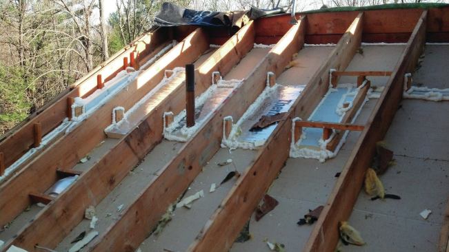 A cathedral-roof rafter bay after retrofit air-sealing and before insulation. Caleb Contracting carried out an extensive roof insulation retrofit after an energy audit revealed the failure of the existing system.