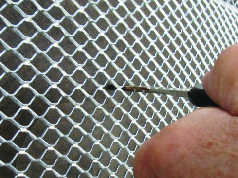 Wire or mesh lath should stand proud of the drainage plane by 1/4 inch. This allows space for the scratch coat of plaster to fully embed the lath. The scratch coat should cover the lath by another 1/8 inch.