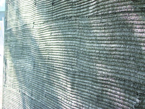 Here is a superior scratch coat that fully covers the lath and has been scored (scarified) to create grooves that will provide a mechanical bond with the brown coat.