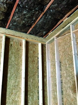 At the perimeter of the ceiling, the crew installed strips of OSB. The Vycor installed across the top plates adheres to the top of this OSB and drywall is secured to the bottom to complete the air barrier across the lid.