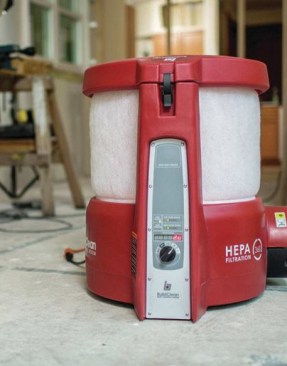 The BuildClean unit pulls air from all sides, first through a prefilter and then through a HEPA filter, before clean air is discharged thorough the port at lower left in the photo above. For lead-safe operations, this port must be hooked up to a discharge hose to eject the filtered air outdoors.