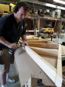 The ceiling framing is assembled on top of the template using 3-inch construction-grade screws.