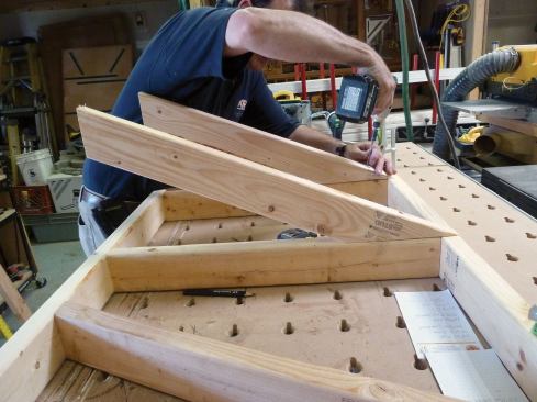 The two common rafters are aligned with and screwed to the joists.