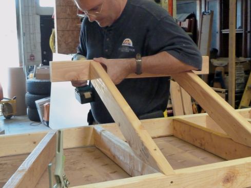 The "ridge" is screwed to the tops of the common rafters.
