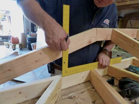 A framing square was placed on the ledger and used to mark the location of the "jack rafters" on the nailers.