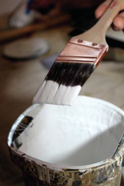 When a brush is dipped in paint, one-half to two-thirds of the bristle length should be wet. Tapping the brush against the side of the can rids it of excessive paint.