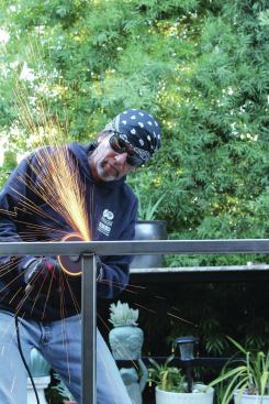 The author, Tom Salas, fabricates his own stainless steel frames; here, he’s smoothing a welded joint.