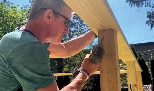 To extend the life of the railing fasteners, the author fastens the top rail to the guard posts from below.