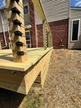 This photo shows the completed railing from the yard and highlights the outside corner. 