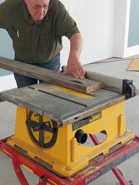 To frame a clipped 45-degree outside corner while preserving a standard 90-degree inside corner where 2x4 stud walls meet at right angles, the author rips both sides of a 2x8 at a 45 degree angle