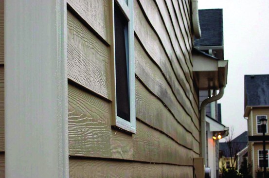 Exterior sheathing can buckle when it dries. Plywood, OSB and fiber board are all affected, and the defect telegraphs to the siding. Photo: Steve Easley