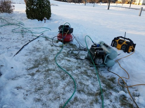 Very cold weather doesn't bother oil-less compressors like Porter-Cable's small pancake compressor (left), while larger oil-lubricated compressors may have difficulty starting.