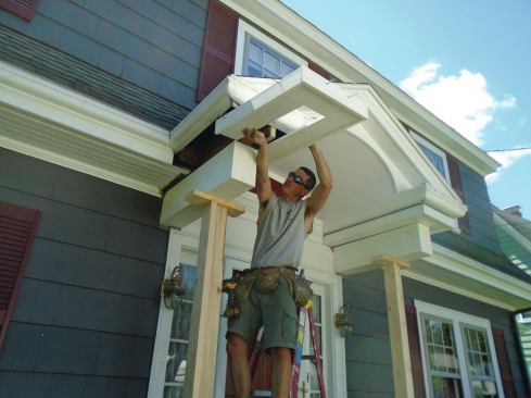 The original beams—which were actually framed like short knee walls and clad with board sheathing—had water damage, so the author reframed them with PT lumber and clad them with PVC trim. Then he prefabricated U-shaped PVC soffit/fascia assemblies and slipped them into place. 