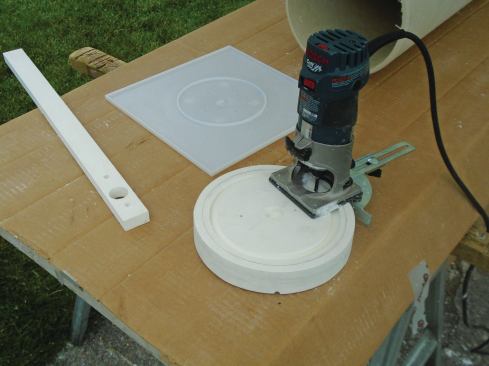 The actual column extensions are another pair of slightly larger PVC plugs sized to match the outside diameter of the columns. The author routed a channel and center hole to match the flashing cap profile, then screwed the extensions to the plugs in the columns with stainless steel screws.