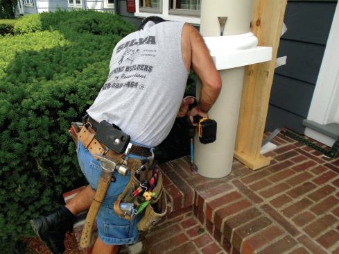 The bases of the columns are secured to the brick porch with 5/16-inch-diameter by  2 3/8-inch-long Tapcon masonry screws driven through the installation clips.