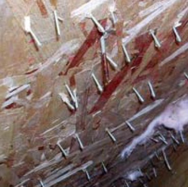 In this case, water can actually be seen dripping off the ends of the staples inside the wall cavities. Best practice calls for a staple or cap nail every 12 to 18 inches along the vertical stud.