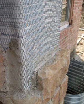 No capillary break. Synthetic stone creates a unique challenge: Unlike brick veneer, which is built in front of an air space, synthetic stone is buttered right to the wall and has no air space to promote drainage. Use two layers of housewrap before installing the lath. The outer layer protects the inner layer from bonding to the mortar holding the stone in place, which allows the inner layer to function as the drainage plane. The natural separation between the layers provides a capillary break to reduce the chance for water wicking through.