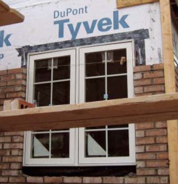 Improper head flashing. The head flashing on this window is reverselapped with the housewrap. Before applying the head flashing, a flap needs to be cut in the housewrap so the head flashing can adhere directly to the wall sheathing and cover the nail fin. Once the flap is folded back down over the head flashing, water draining down the wall above the window will drain outside, not behind the head flashing.