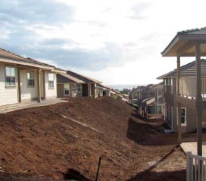 Dreadful drainage. In this coastal subdivision, water running off one series of houses drains right into another. There is not enough natural drainage away from the lower structures to prevent subslab moisture.