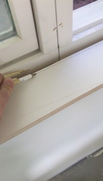 Here, a compass is used to scribe a window sill; this technique can be used for baseboard too. Set the compass to the amount that needs to be removed and run the tool as shown.