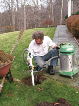 You’re always disturbing the soil at the bottom of the hole as you dig and it’s hard to scrape it out, especially from deep holes. One trick for removing the loosened soil is to vacuum it out.