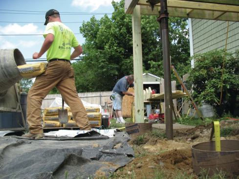 A pier should extend a few inches above grade so that the hardware used to connect the PT post to the pier won’t get covered with soil. 