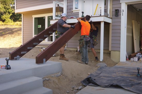 At the porch end, the stringers were attached with structural screws driven through a doubled rim joist.