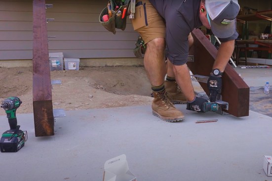 The author uses an impact driver to tighten one of the bottom tread brackets.