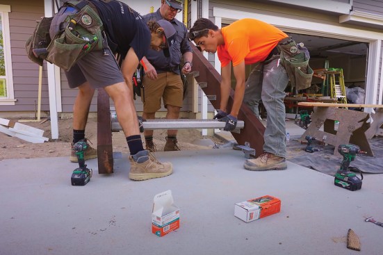 Each concrete tread weighs 105 pounds, so two workers set them in place.