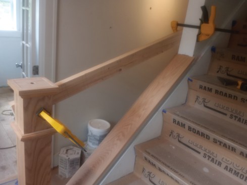 With the story pole clamped in place, lines are plumbed to the wall cap and marked to the handrail. By templating, the author could visualize the completed product before drilling finish material.