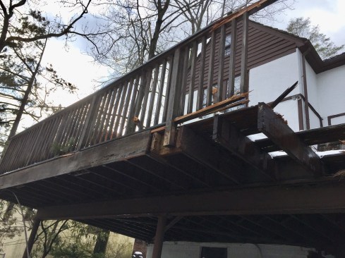Though the original deck sustained damage when a tree fell on it during a windstorm, it was probably due for replacement anyway thanks to sketchy ledger connection details and extensive rot. The columns and W10 steel girder supporting the deck were the only components that were reused.