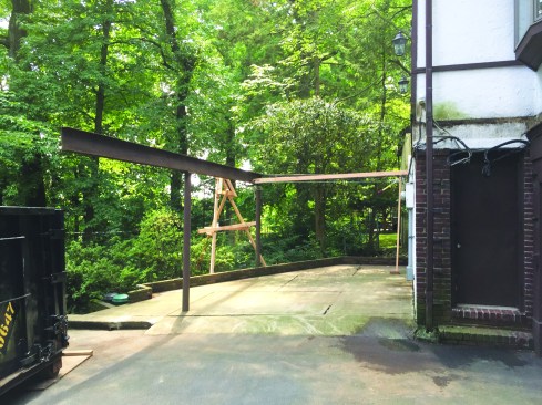 The columns and W10 steel girder supporting the deck were the only components that were reused. To stabilize the steel girder, the crew braced it with a 2-by and a cable tensioned by a come-along.