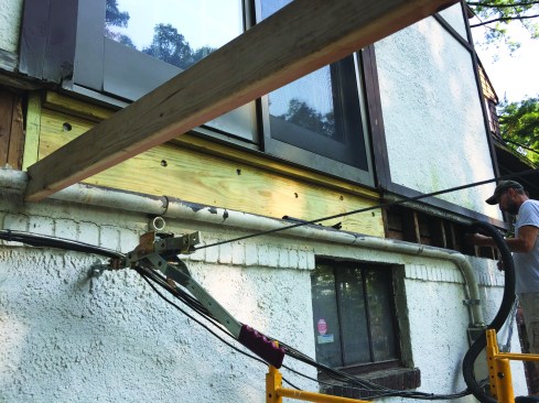 A solid PT header was installed underneath the slider to replace the cripples.
