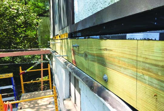 The new ledger was lag-bolted to the house framing.