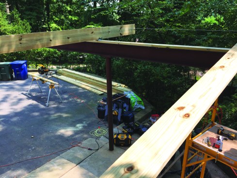 The old girder was primed, painted, and capped with a flashing membrane and a treated 2x6 plate.