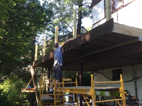 Once the deck was reframed, workers installed new composite decking and fascia and a composite rail system.